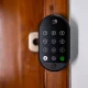 a black electronic lock on a wooden door